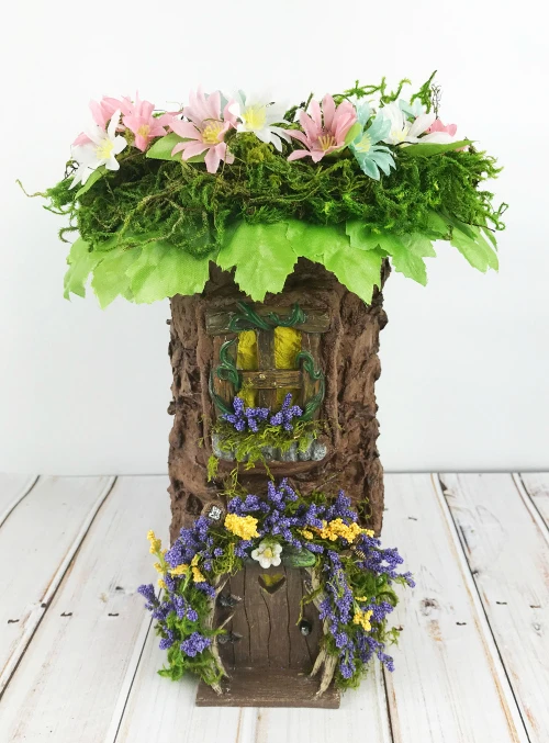 Add fake leaves and flowers to the fairy garden tree topper.